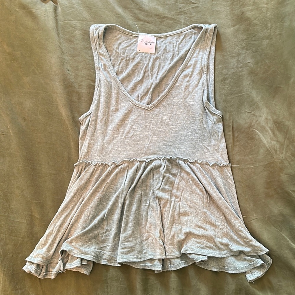 Teal tank top, very light material. Great for a beach day!